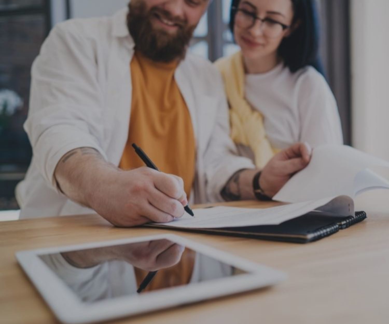 Young couple signing contract